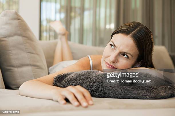 woman on sofa - negligée stock-fotos und bilder