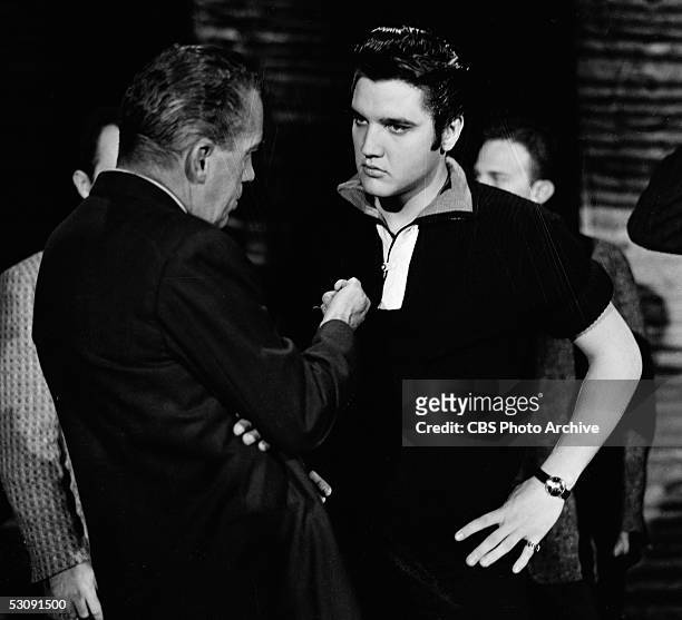American television personality Ed Sullivan talks with singer and musician Elvis Presley backstage at 'The Ed Sullivan Show,' Los Angeles,...