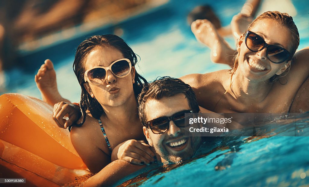 Friends having fun in a swimming pool.