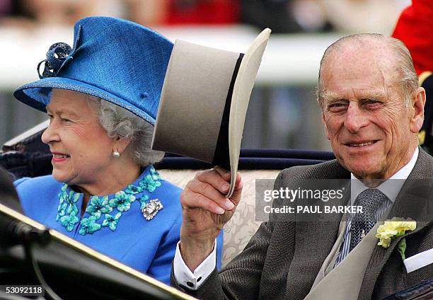 Britain's Queen Elizabeth and the Duke of Edinburgh arrive on the fourth day of the Royal Ascot meeting being held at York Racecourse in York,...