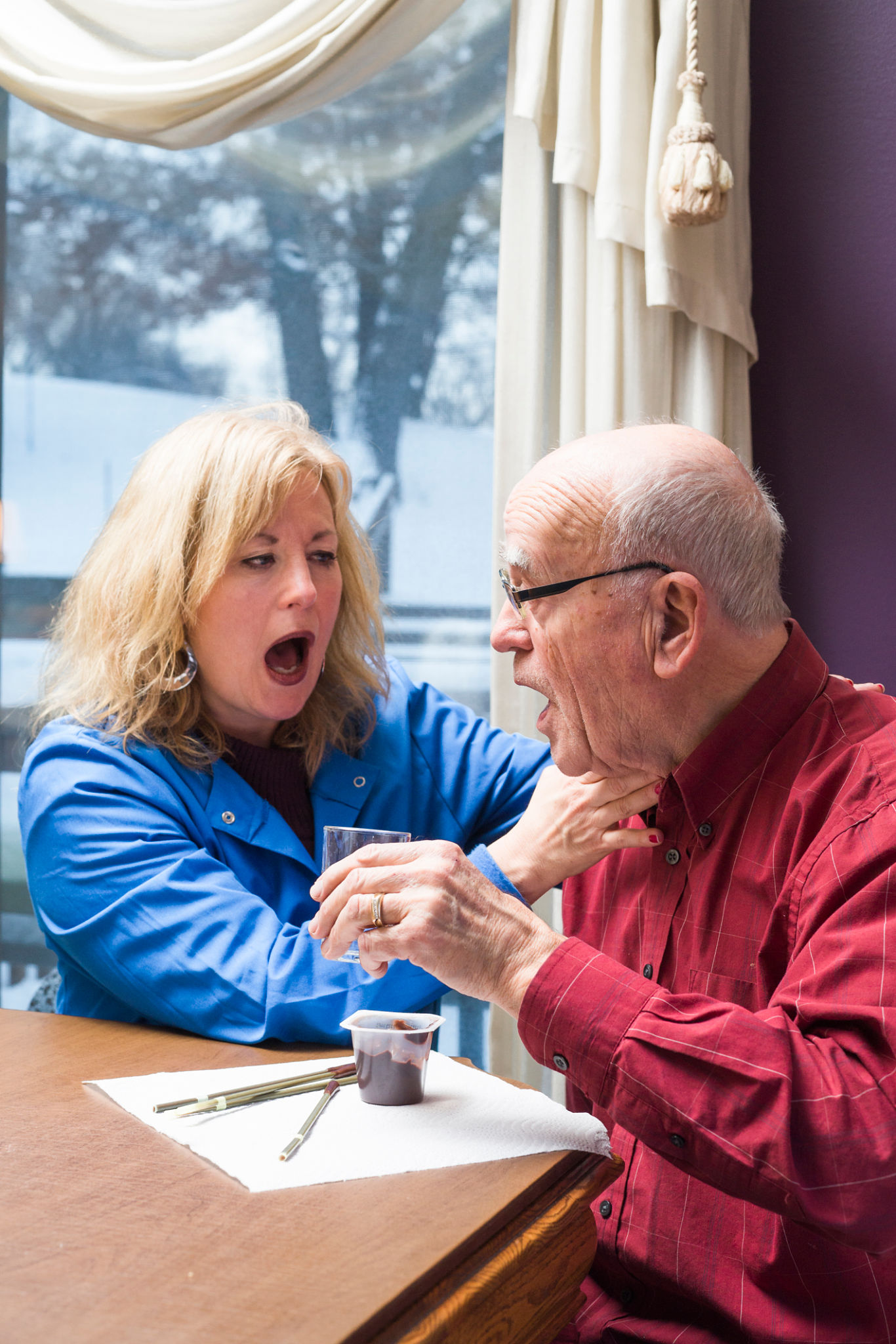 Speech therapist listens for dry voicing after swallowing Speech therapist listens for dry voicing after swallowing