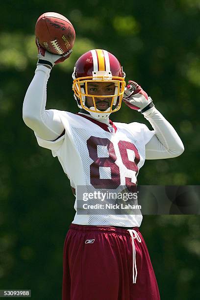 Santana Moss of the Washington Redskins tosses the ball during the Redskins Mini Camp on June 17, 2005 at Redskins Park in Ashburn, Virginia.