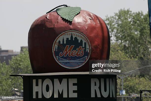 The 'big apple' - a Mets home run tradition - rises out of a top hat located behind the center field wall during the game between the New York Mets...