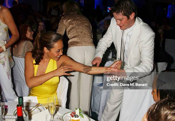 Magician performs a trick on Myleene Klass at the Nordoff-Robbins Silver Clef Awards at the Hotel Inter-Continental on June 17, 2005 in London,...