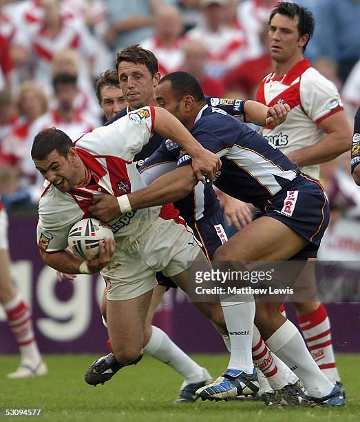 Mike Bennett of St.Helens is tackled by Joe Mbu of London during the Engage Super League match between St.Helens and London Broncos at Knowsley Road...