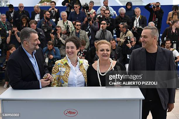 Romanian director Cristi Puiu poses on May 12, 2016 with Romanian producer Anca Puiu , Romanian actress Dana Dogaru and Romanian actor Mimi Branescu...