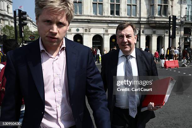An assistant attempts to block photographs being taken of Secretary of State for Culture, Media and Sport, John Whittingdale , as he walks to...