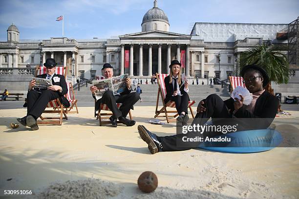 Protesters from Oxfam, Action Aid and Christian Aid stage a protest to demonstrate against tax havens at Trafalgar Square during the Global...