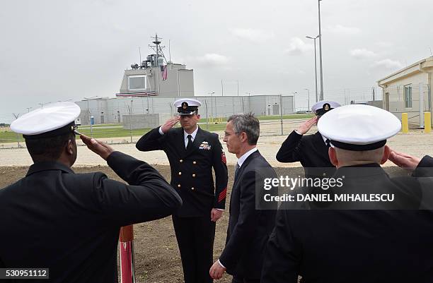 Secretary General Jens Stoltenberg reviews an honour guard during an inauguration ceremony of the US anti-missile station Aegis Ashore Romania at the...