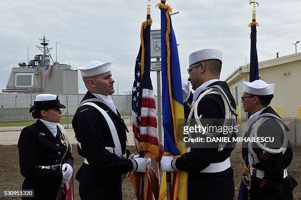 Army personnel stand with the Romanian and the US flag during an inauguration ceremony of the US anti-missile station Aegis Ashore Romania at the...