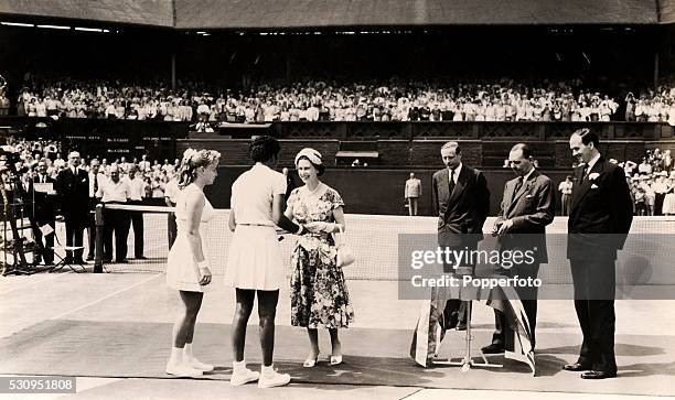 Althea Gibson of the United States, the first black champion in the tournament's 80-year history, is congratulated by HM Queen Elizabeth II after...