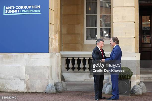 Foreign Office Minister Hugo Swire greets Colombian President Juan Manuel Santos, at Lancaster House for the international anti-corruption summit on...