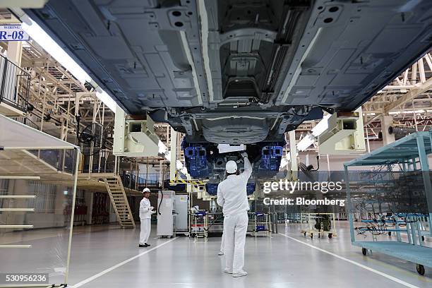Employees assemble parts of Honda Civic vehicles on the assembly line of the Honda Motor Co. Assembly plant in Prachinburi, Thailand, on Thursday,...