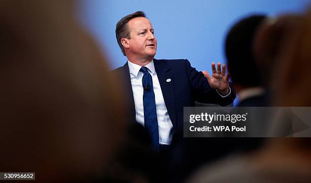 British Prime Minister David Cameron gestures during a panel discussion at the international anti-corruption summit on May 12, 2016 in London,...