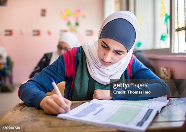 Amman, Jordan Teaching at the school bilayer Al Quds , Amman. There Jordanian and Syrian children are taught in separate layers on April 03, 2016 in...