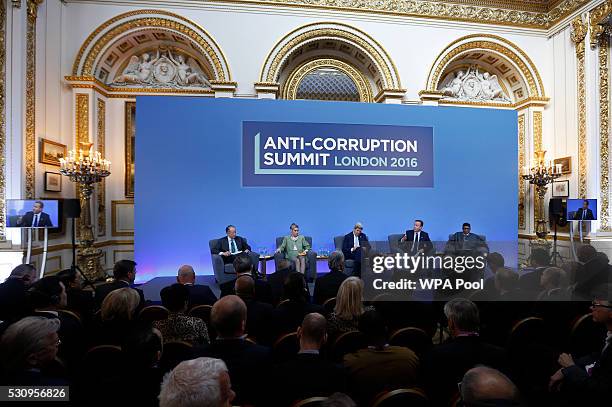 World Bank President Jim Yong Kim, Sarah Chayes, U.S. Secretary of State John Kerry, British Prime Minister David Cameron and Nigeria President...