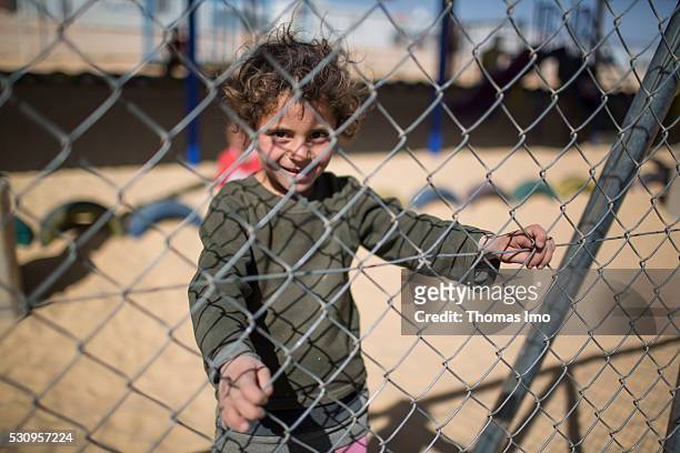 Amman, Irbid Child on a fenced playground in refugee - camp Zaatari on April 04, 2016 in Amman, Irbid.