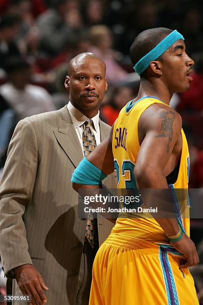 Smith of the New Orleans Hornets stands near his head coach Byron Scott during the game against the Chicago Bulls on March 18, 2005 at the United...