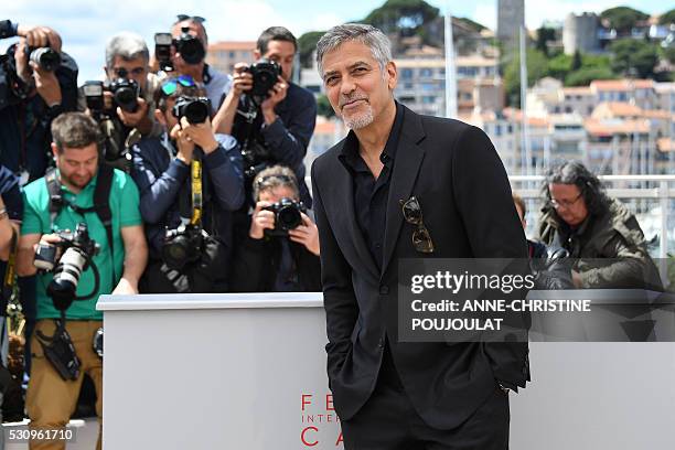 Actor George Clooney poses on May 12, 2016 during a photocall for the film "Money Monster" at the 69th Cannes Film Festival in Cannes, southern...