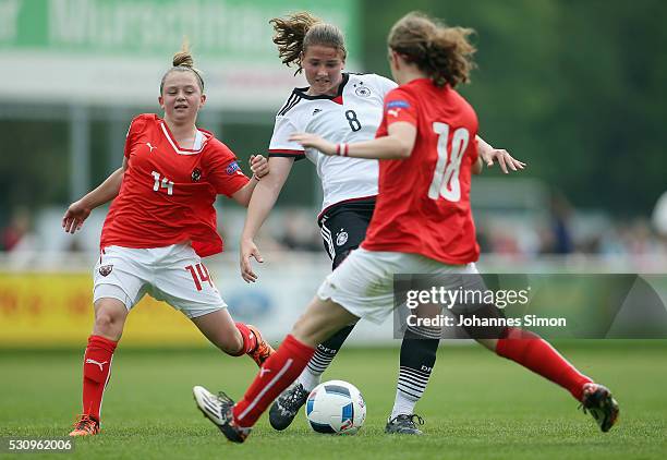 Lisa Ebert of Germany fights for the ball with Maria Plattner and Melanie Brunnthaler of Austria during the U16 girl's international friendly between...