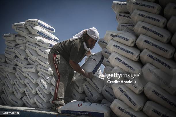 Palestinian worker carries cement sacks after he unloaded them from trucks from Rafah border in Rafah, Gaza on May 12, 2016. Egyptian authorities has...