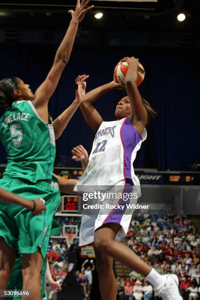 DeMya Walker of the Sacramento Monarchs attempts a shot against Stacey Lovelace-Tolbert of the Minnesota Lynx during the WNBA game on June 17, 2005...