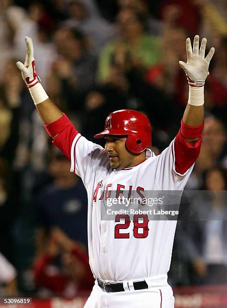 Jose Molina of the Los Angeles Angels of Anaheim celebrates as the Angels defeat the Florida Marlins in extra innings 3-2 on June 17, 2005 at the...