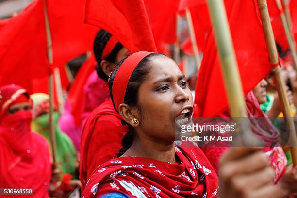 Garment worker attends a rally with a flag and shouts slogans during a Labour Day protest in Dhaka, Bangladesh, May 01, 2016.Thousands of workers of...