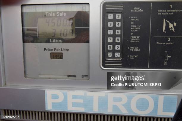 The new fuel price of 145 naira per litre is displayed in pumping machine at a filling station in Lagos, on May 12, 2016. - Nigeria hiked the price...