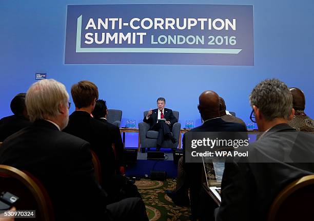 Colombia President Juan Manuel Santos speaks on the podium during a panel discussion at the international anti-corruption summit on May 12, 2016 in...