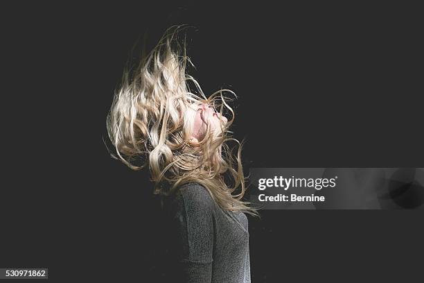 blonde female with hair over face - obscured face ストックフォトと画像