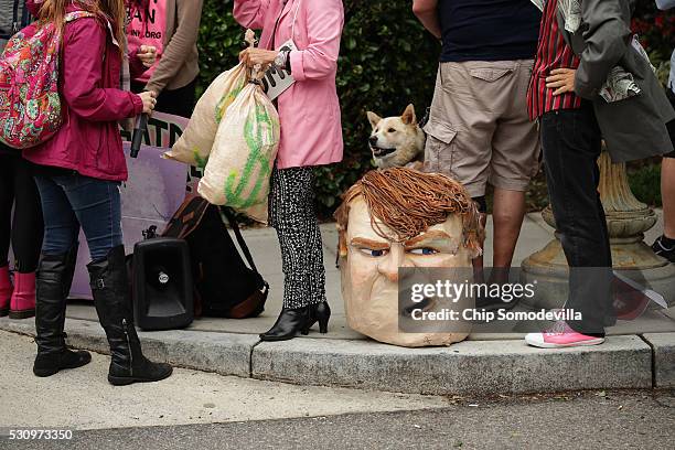 Protesters from Code Pink for Peace gather near Republican presidential candidate Donald Trump's motorcade outside the Republican National Committee...