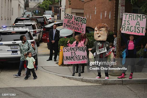 Protesters from Code Pink for Peace gather near Republican presidential candidate Donald Trump's motorcade outside the Republican National Committee...