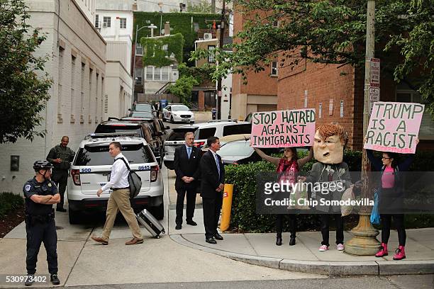 Protesters from Code Pink for Peace gather near Republican presidential candidate Donald Trump's motorcade outside the Republican National Committee...