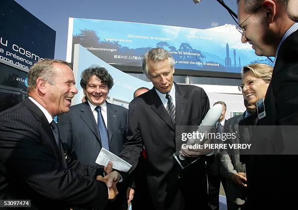 French Prime Minister Dominique de Villepin talks to Arianespace CEO Jean-Yves Le Gall after receiving a model of the Ariane 5 rocket during his...