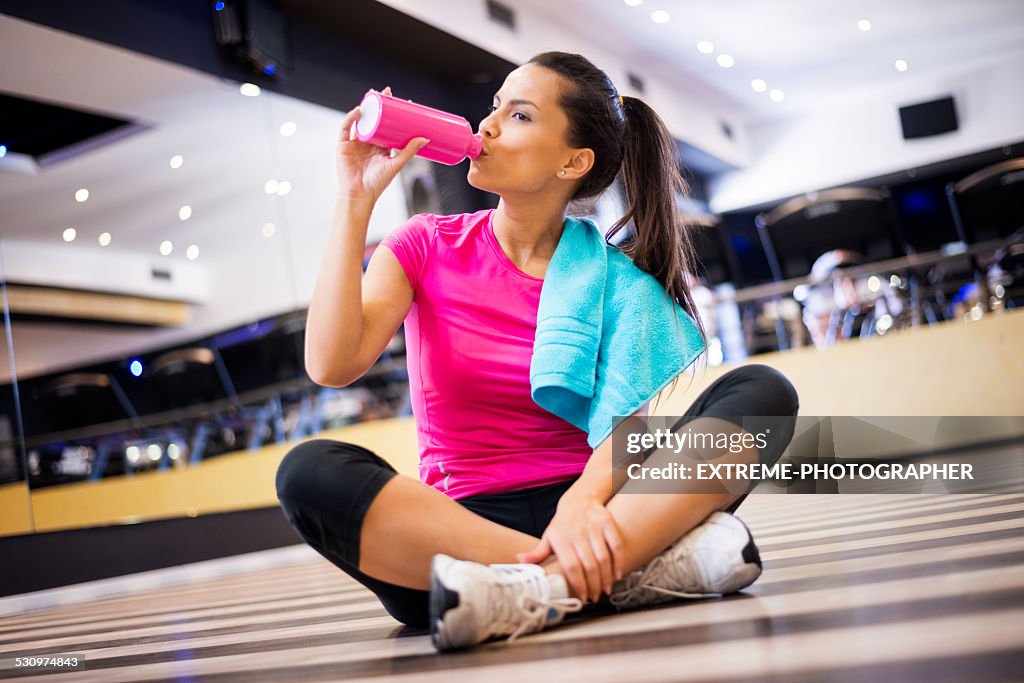 Woman in the gym hydrating