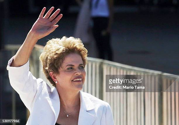 Suspended Brazilian President Dilma Rousseff waves before speaking to supporters at the Planalto presidential palace after the Senate voted to accept...