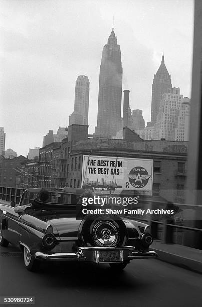 Marilyn Monroe with her husband, the playwright Arthur Miller, driving in a convertible Ford Thunderbird in 1957 in New York, New York.