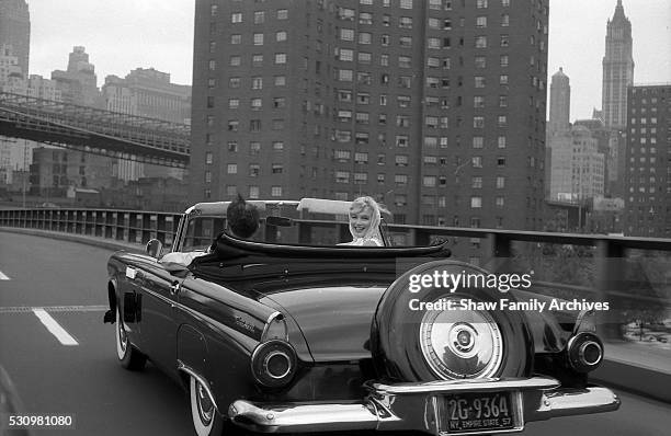 Marilyn Monroe with her husband, the playwright Arthur Miller, in a convertible Ford Thunderbird in 1957 in New York, New York.