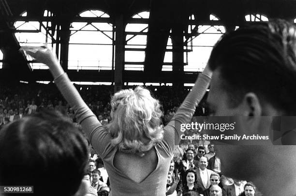 Marilyn Monroe waves to the crowd at the ceremonial kick off for a match between a combined Israeli Hapoel team and the American Soccer League Stars...