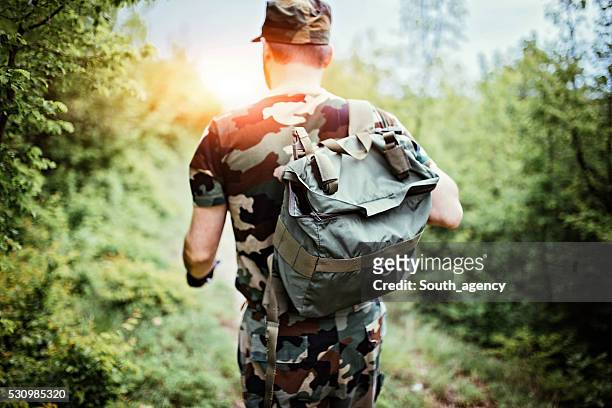 soldier with backpack - woodland camo stock pictures, royalty-free photos & images
