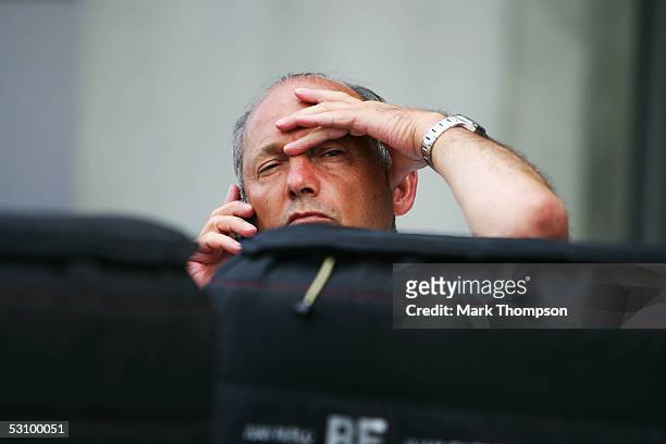 Team principal of McLaren Ron Dennis speaks on the phone after qualifying for the United States F1 Grand Prix at the Indianapolis Motor Speedway on...