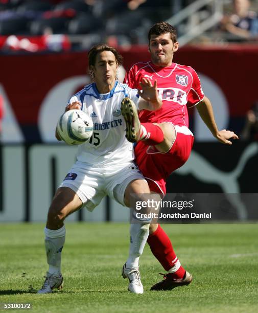 Gonzalo Segares of the Chicago Fire kicks the ball around Josh Wolff of the Kansas City Wizards on June 18, 2005 at Soldier Field in Chicago,...