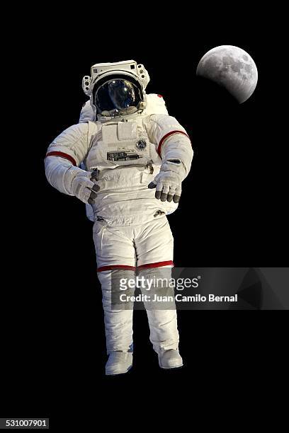 astronaut with the moon in the back - cosmonaut stockfoto's en -beelden