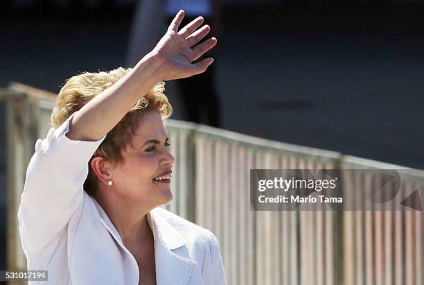 Suspended Brazilian President Dilma Rousseff waves before speaking to supporters at the Planalto presidential palace after the Senate voted to accept...