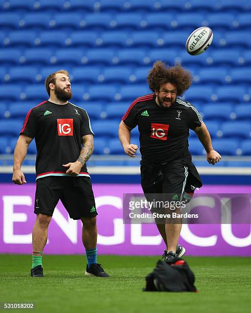 Adam Jones heads a ball as Joe Marler looks on during the Harlequins Captain's Run on the eve of the European Rugby Challenge Cup Final match against...
