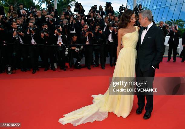 Actor George Clooney , and his wife British-Lebanese lawyer Amal Clooney pose on May 12, 2016 as they arrive for the screening of the film "Money...