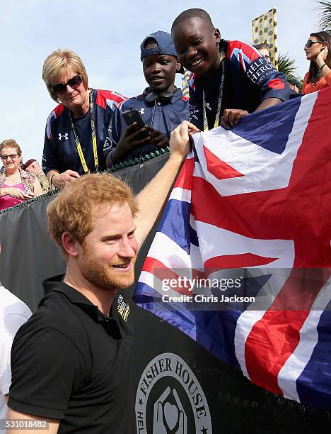 Prince Harry greets a young fan at the wheelchair tennis on the final day of the Invictus Games Orlando 2016 at ESPN Wide World of Sports on May 12,...