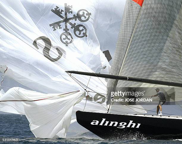Crew member of the Swiss Team Alinghi saves the Spinaker, off Valencia coast 19 June 2005, during the fourth leg of the match racing pre-regata for...