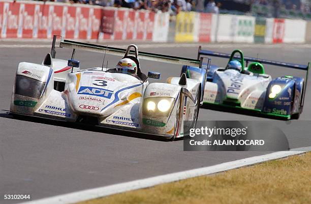 Danish Tom Kristensen leads the last lap with his Audi-Champion R8 number 3, during the 73rd edition of Le Mans 24 Hours car race followed by...